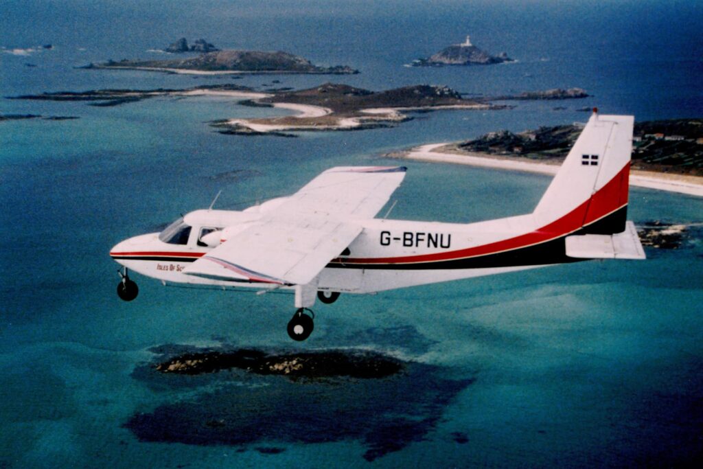 Skybus islander aircraft flying in original livery