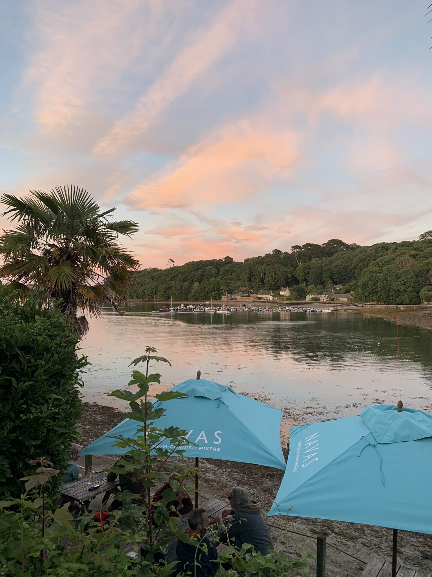 Golden evening light reflecting on the Helford River viewed from The Shipwrights Inn, Cornwall.