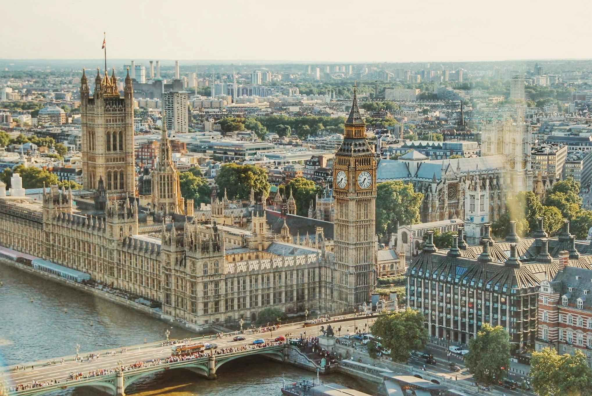 Bird’s-eye view of Big Ben and the adjoining Houses of Parliament with surrounding cityscape.