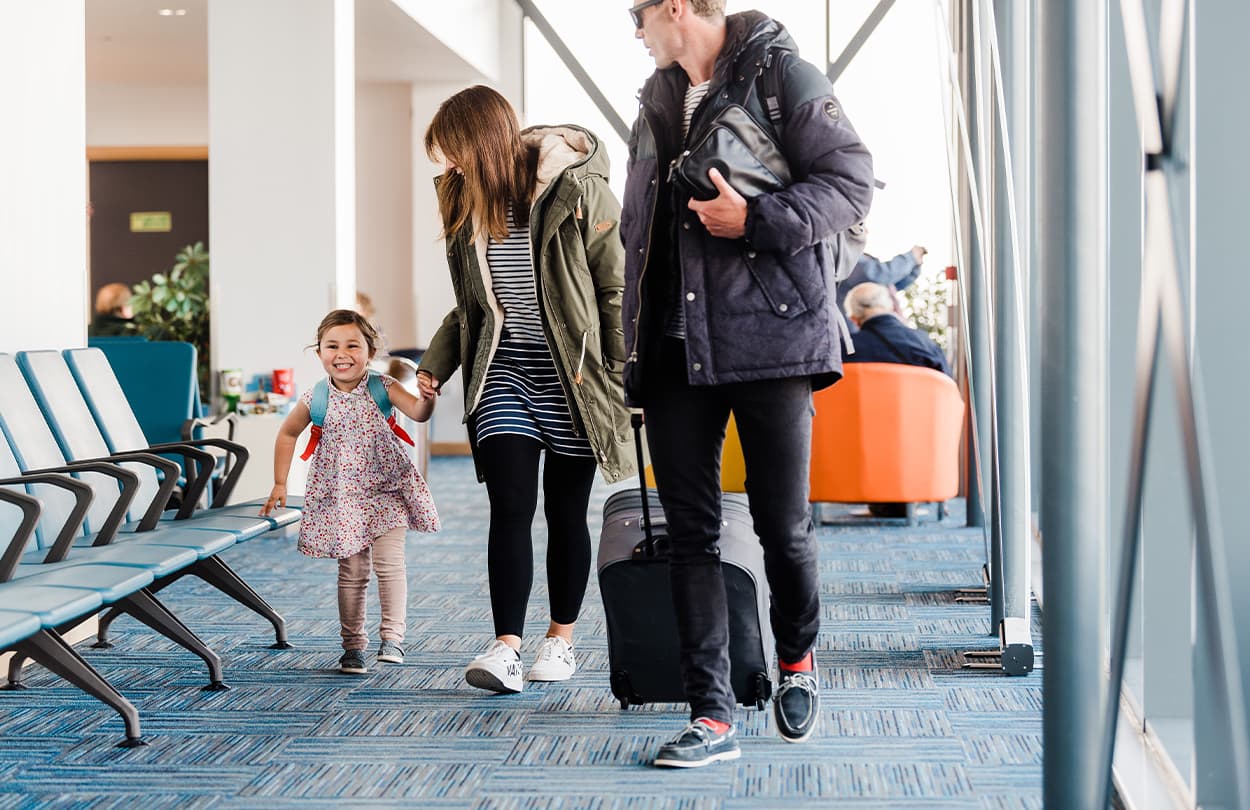 Family walking through an airport terminal