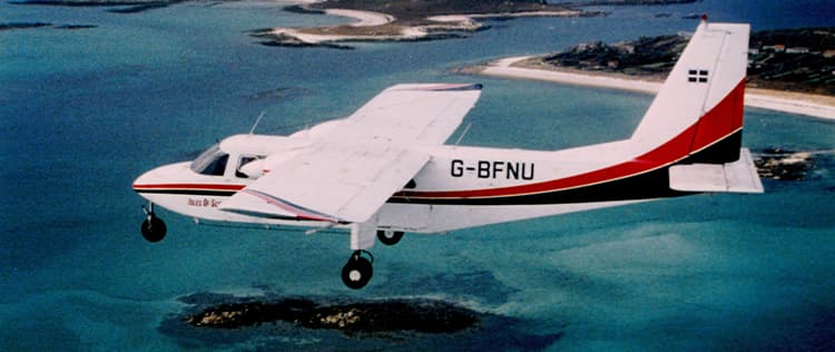 Historic image of Skybus islander G-BFNU in the orginal livery flying above the Isles of Scilly